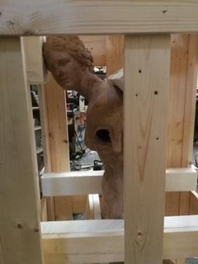 Sculpture held in a braced crate frame